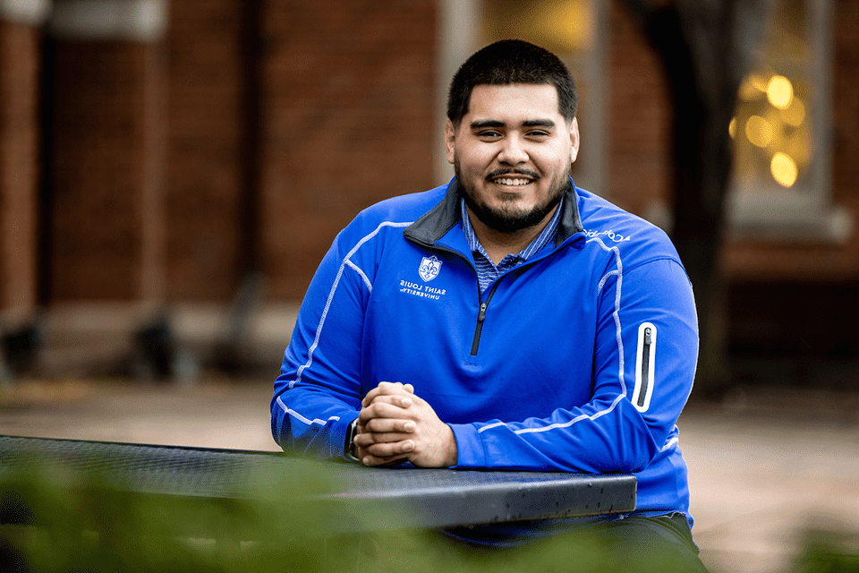 Gael Cosgaya sits at a table at the School of Business